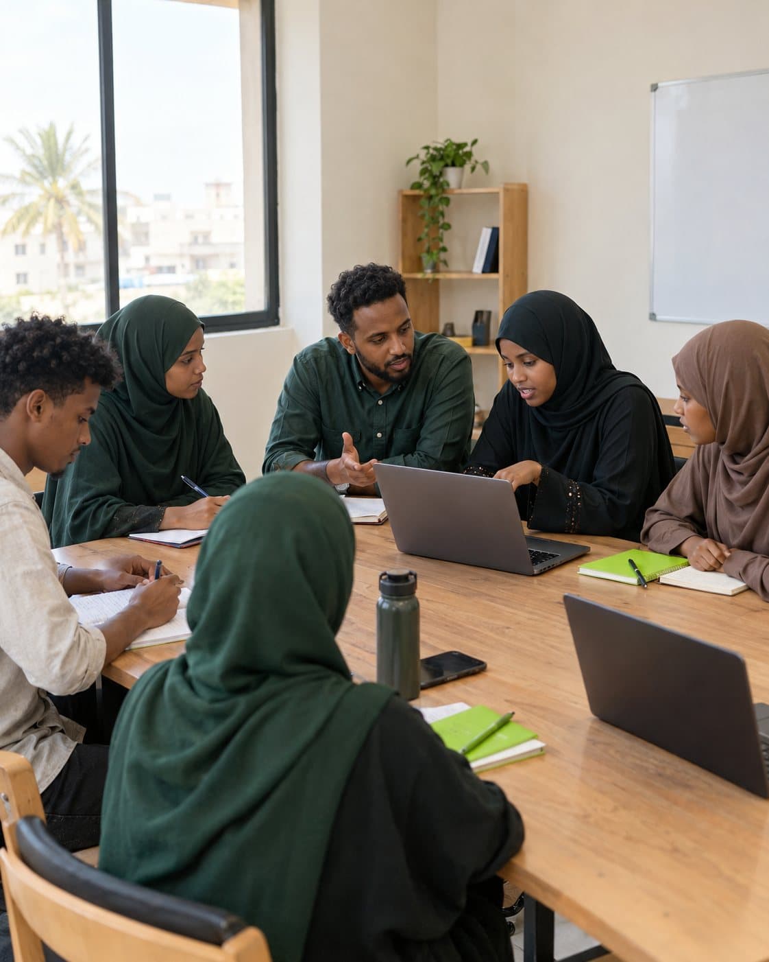 Young Somali women and men learning digital skills together with a mentor at a Youthup workshop